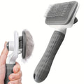 PluffBrush in use removing loose fur from a cat